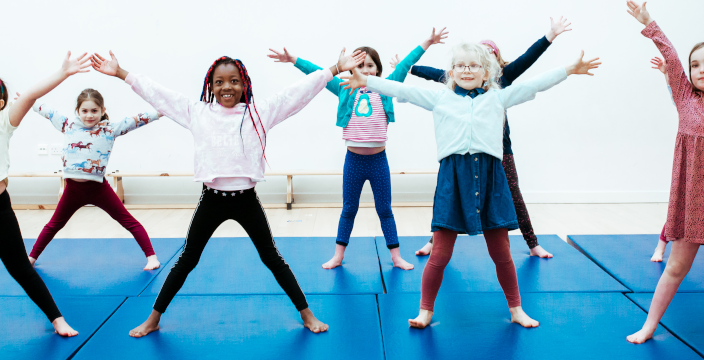 A group of girls enjoy a Premier Education dance club as part of a Performing Arts Holiday Camp.