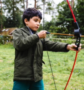 Child doing archery at a Premier Education Holiday Camp