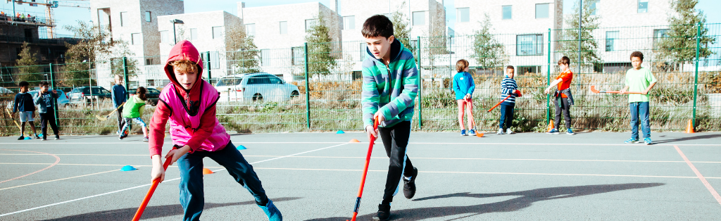 Children playing hockey at a Premier Education Holiday Camp
