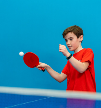 Child playing table tennis