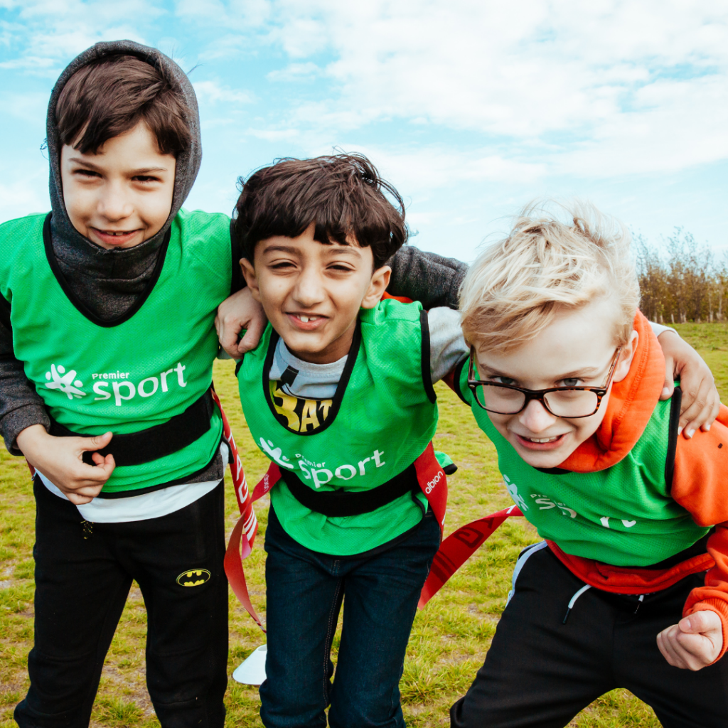 three boys enjoying Premier Education tag rugby