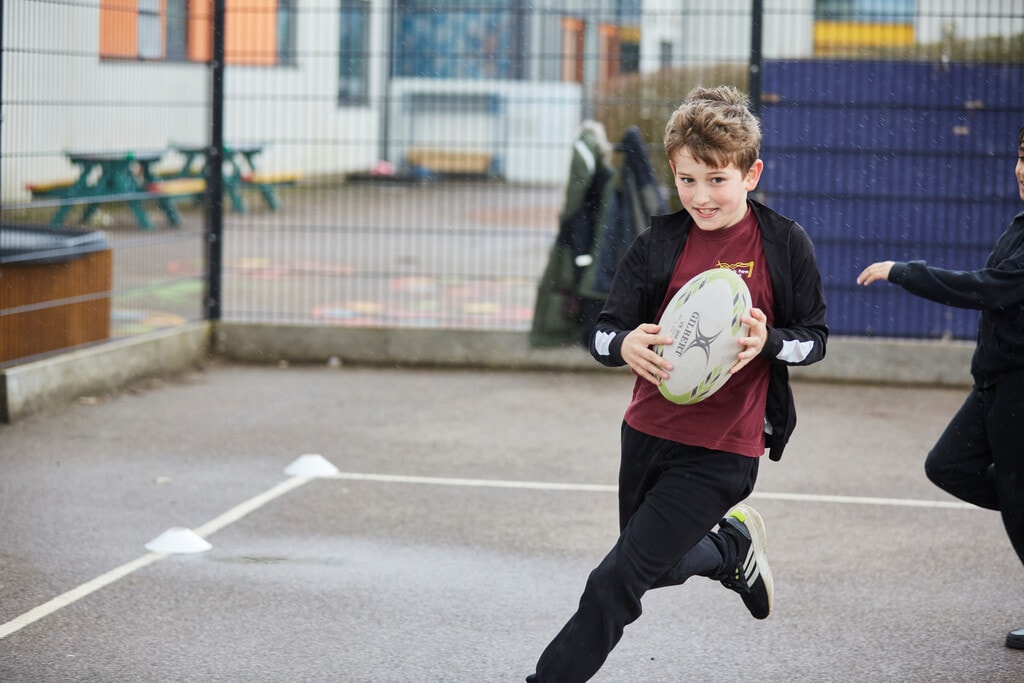 The Most Popular Sports Across the World 1 Child playing rugby on a sports field