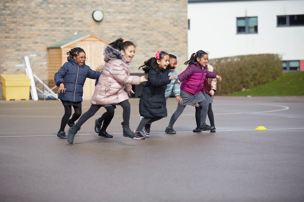 The Ultimate List of Fun PE Games for Primary Schools 10 Pupils enjoying a tag game