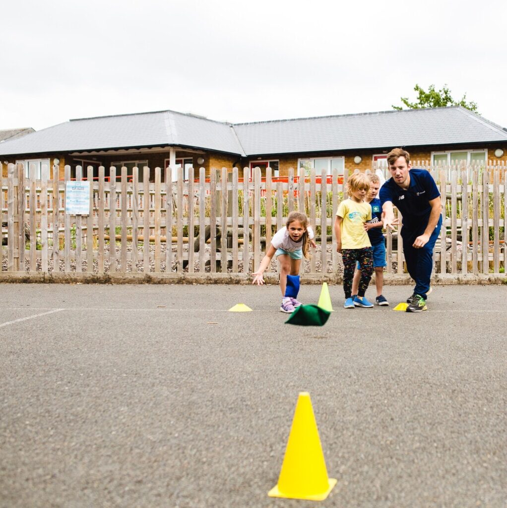 The Ultimate List of Fun PE Games for Primary Schools 7 Children playing throwing games with help with hand-eye coordination